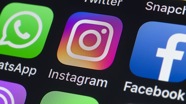 London, UK - July 24, 2018: The buttons of WhatsApp, Instagram, facebook, Twitter, Snapchat and other apps on the screen of an iPhone.