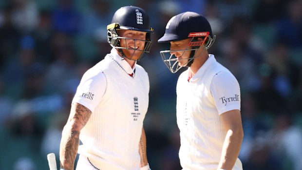 Ben Stokes of England speaks with Harry Brook.