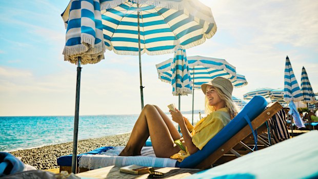 Young adult woman relaxing at a luxury hotel on holiday in the Côte d'Azur, France.