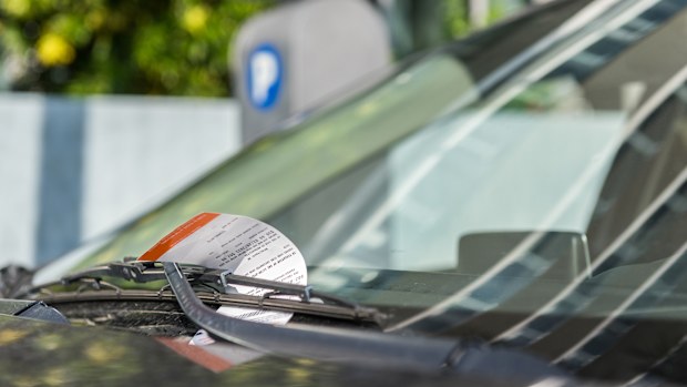 Parking ticket displayed on the windshield of a car.