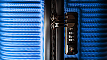 Stylish blue suitcase with combination lock.