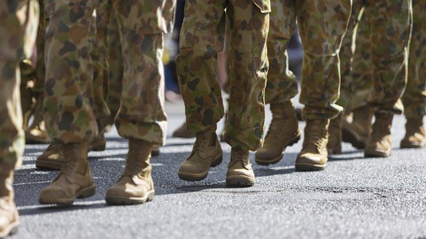 Feet of soldiers marching at an ANZAC Day parade on the streets of a regional country town