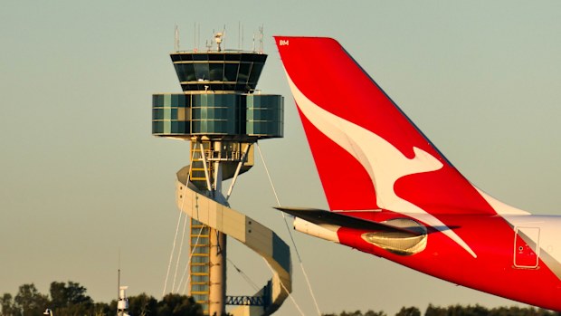 A Qantas Airbus A330-202 plane, registration VH-EBM, passing the air traffic control tower as she taxis at Sydney Kingsford-Smith Airport in preparation for departure as flight QF43 to Denpasar. 