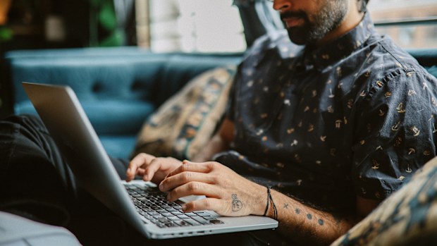 Young man working from home, doing IT work from his home in Los Angeles, California.