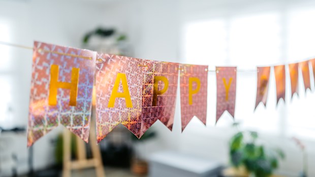 Happy birthday banner sign in a domestic room.