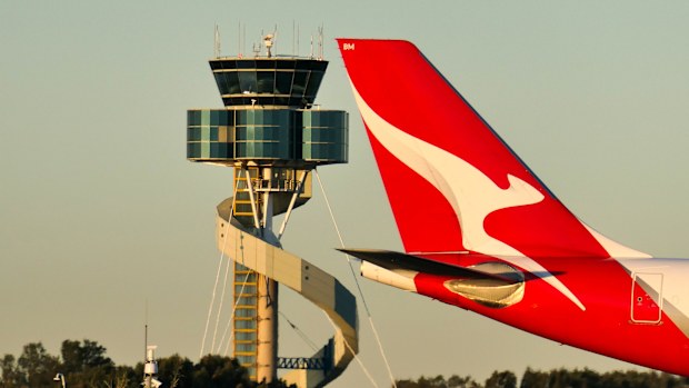 A Qantas Airbus A330-202 plane, registration VH-EBM, passing the air traffic control tower as she taxis at Sydney Kingsford-Smith Airport in preparation for departure as flight QF43 to Denpasar. 