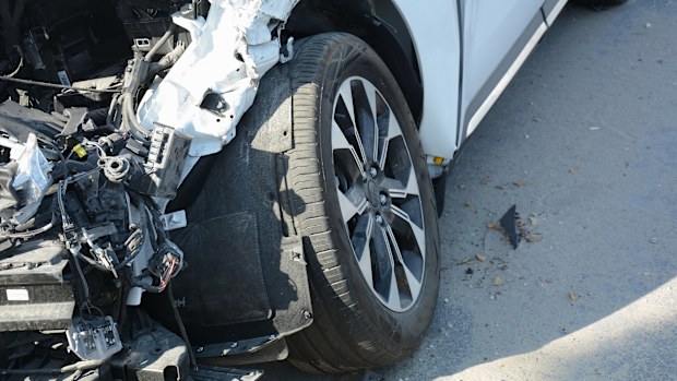 Car crash or accident. Front fender and light damage . Broken vehicle detail or close up.