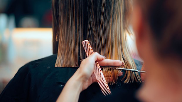 Professional beauty salon worker executing perfect ends trimming