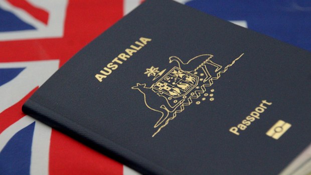 Australian passport with background of Australian flag