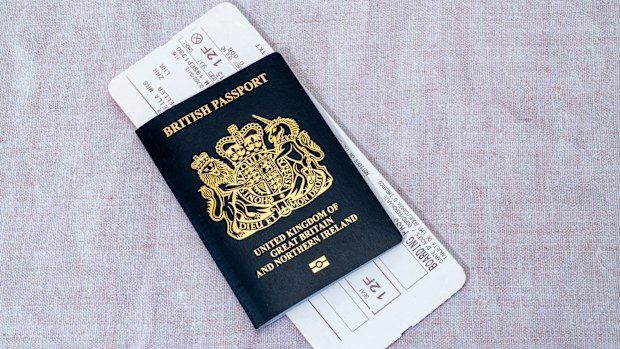 London, United Kingdom - March 7th, 2023 :   A new blue British passport with an airline boarding pass.  Since the United Kingdom has left the European Union in 2020, new British passports have returned to their original blue colour.