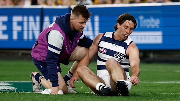 Geelong's Jack Henry is seen to by medical staff during the preliminary final against Hawthorn.