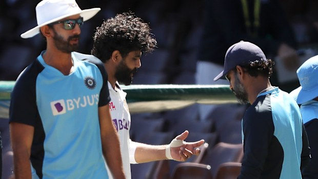 Ravindra Jadeja speaks to a member of the India team staff.