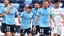 Adrian Segecic of Sydney FC celebrates with teammates after scoring a goal.