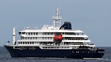 The MV Hondius cruise ship departs the port in Praia, Cape Verde.