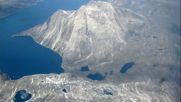 An aerial view of melt water lakes on the edge of an ice cap in Nunatarssuk, Greenland. 