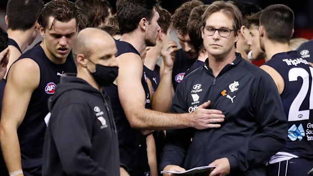 David Teague is consoled by Mitch McGovern of the Blues.