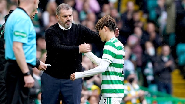 Celtic's Kyogo Furuhashi shakes hands with manager Ange Postecoglou. 