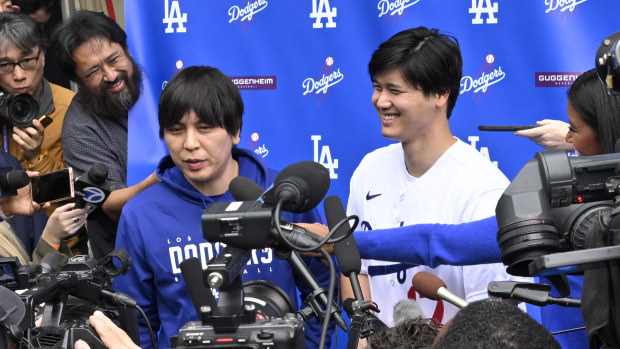 Shohei Ohtani, right, of the Los Angeles Dodgers speaks to the media with the help of his interpreter Ippei Mizuhara during DodgerFest a celebration of the upcoming season with live entertainment, behind-the-scenes experiences, food, drinks and meeting the newest Dodgers at Dodger Stadium in Los Angeles on Saturday, February 3, 2024. (Photo by Keith Birmingham/MediaNews Group/Pasadena Star-News via Getty Images)