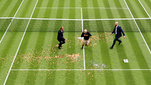 A protester trespasses on to court 18 in a Just Stop Oil protest during the women's singles first round match between Katie Boulter and Australia's Daria Saville of Australia during day three of The Championships Wimbledon.