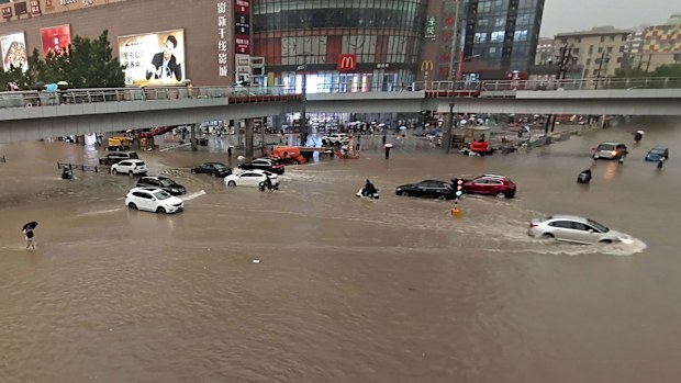 Vehicles are stranded after a heavy downpour in Zhengzhou city, central China's Henan province.