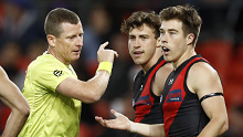 Zach Merrett of the Bombers questions the umpire.