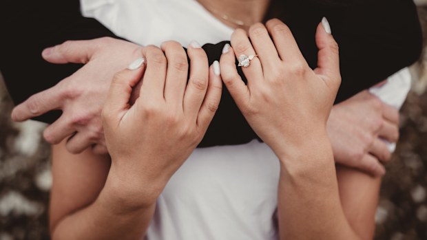 Engaged couple embracing close up