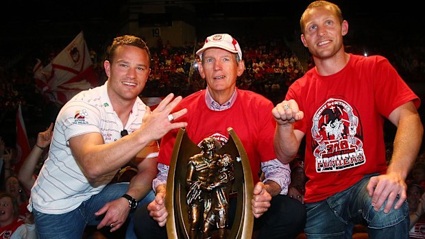 Wayne Bennett (centre) has won seven premierships as a coach.