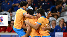 Nicolas Freitas of Uruguay celebrates with his teammates after scoring his team's first try during the Rugby World Cup.