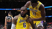 Cropped: LeBron James #6 of the Los Angeles Lakers reacts with Thomas Bryant #31 after drawing a foul on a basket against the Atlanta Hawks during the fourth quarter at State Farm Arena on December 30, 2022 in Atlanta, Georgia. (Photo by Kevin C. Cox/Getty Images)