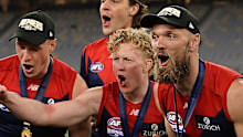 Clayton Oliver, Max Gawn and Tom McDonald celebrate the 2021 premiership. 