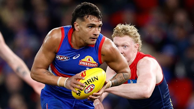 MELBOURNE, AUSTRALIA - AUGUST 02: Jamarra Ugle-Hagan of the Bulldogs and Clayton Oliver of the Demons in action during the 2024 AFL Round 21 match between Footscray and the Melbourne Demons at Marvel Stadium on August 02, 2024 in Melbourne, Australia. (Photo by Michael Willson/AFL Photos via Getty Images)