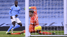 Manchester City's Benjamin Mendy, left, scores his side's third goal during the English Premier League soccer match between Manchester City and Burnley at the Etihad stadium in Manchester, England, Saturday, Nov. 28, 2020. (Laurence Griffiths/Pool via AP)