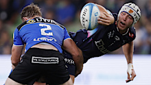 Josh Canham of the Rebels passes the ball at AAMI Park.