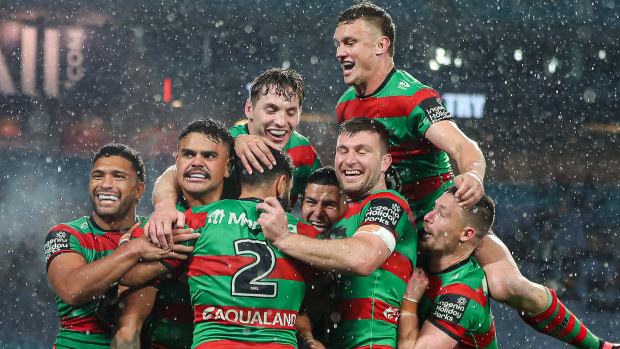 Alex Johnston and teammates celebrating his record-breaking 191st NRL try, scored against the Broncos.