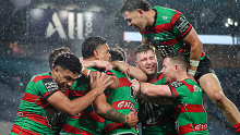 Alex Johnston and teammates celebrating his record-breaking 191st NRL try, scored against the Broncos.