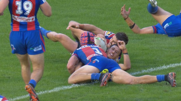 Kalyn Ponga attempts to make a try-saving tackle on Isaiah Iongi.
