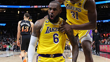 LeBron James #6 of the Los Angeles Lakers reacts with Thomas Bryant #31 after drawing a foul on a basket against the Atlanta Hawks during the fourth quarter at State Farm Arena on December 30, 2022 in Atlanta, Georgia. (Photo by Kevin C. Cox/Getty Images)