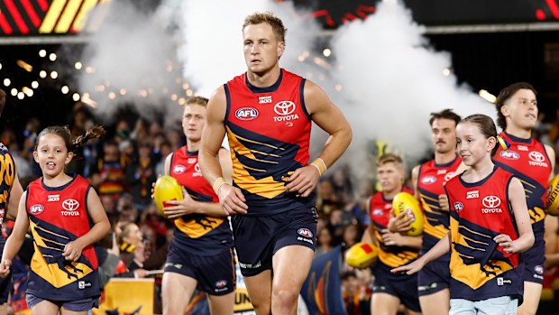 Jordan Dawson leads Adelaide onto the field.