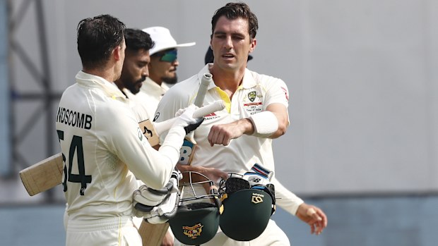 Pat Cummins and Peter Handscomb of Australia interact during day one of the Second Test match in the series between India and Australia at Arun Jaitley Stadium on February 17, 2023 in Delhi, India. (Photo by Pankaj Nangia/Getty Images)