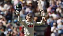 Alex Carey looks to the sky after his ton. 