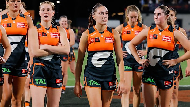 The GWS Giants AFLW team leave the field after a loss.