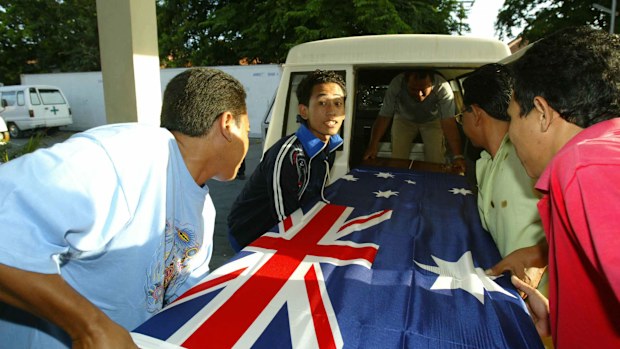 Three coffins containing Australian victims of the 2005 Bali bombings, draped in an Australian flag.