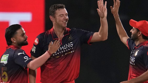 Royal Challengers Bengaluru's Josh Hazlewood celebrates the wicket of Delhi Capitals' Sameer Rizvi.