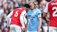 Gabriel of Arsenal clashes with Erling Haaland of Manchester City.