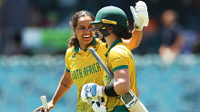 Chloe Tryon of and  Laura Wolvaardt of South Africa celebrate victory during game two of the Women's T20 International series between Australia and South Africa at Manuka Oval on January 28, 2024 in Canberra, Australia. (Photo by Mark Metcalfe/Getty Images)