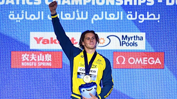 Isaac Cooper celebrates his World Aquatics Championships gold medal.