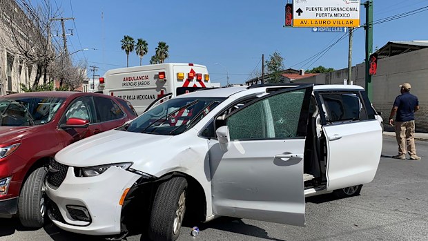 A member of the Mexican security forces stands next to a white minivan with North Carolina plates and several bullet holes, at the crime scene where gunmen kidnapped four US citizens who crossed into Mexico from Texas, Friday, March 3, 2023. 