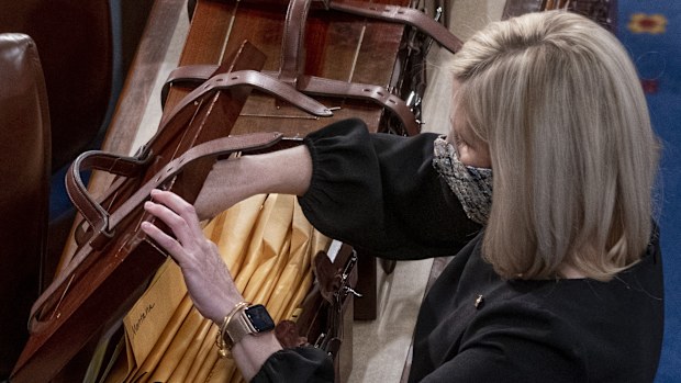 Boxes containing Electoral College votes are opened as a joint session of the House and Senate