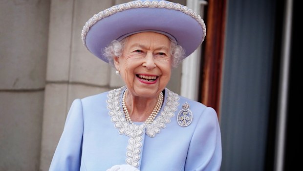 Queen Elizabeth II watches with a smile from the balcony of Buckingham Palace after the Trooping the Color ceremony in London, Thursday, June 2, 2022, on the first of four days of celebrations to mark the Platinum Jubilee. The events over a long holiday weekend in the U.K. are meant to celebrate the monarch's 70 years of service. (Jonathan Brady/Pool Photo via AP)