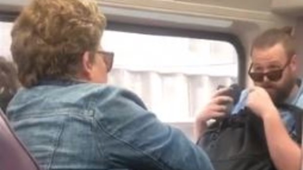 Woman coughs on commuter sparking bitter argument amid coronavirus fears.